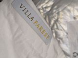 the label of a white jacket with a gold logo on it