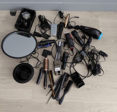 beaucoup de sèche-cheveux et d'autres accessoires pour les cheveux par terre
