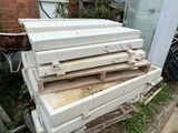 a pile of wood sitting in front of a brick building