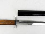 two knives that are laying side by side on a table