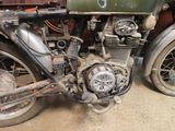 an old motorcycle that is sitting in a garage