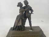 statue of a man and a woman dancing on a pedestal