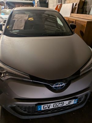 a car that is parked in a garage with other cars in the background