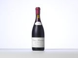 the bottle of wine is sitting on the table with a white background