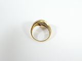 a close up of a gold ring on a white surface