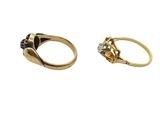 two gold rings with black and white diamonds on them