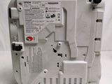 the back side of a white electronic device with a red button