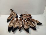 six pairs of black and gold high heeled shoes with pearls on them
