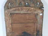 an old wooden frame with a mirror on it