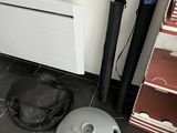a vacuum cleaner sitting on the floor next to a bag