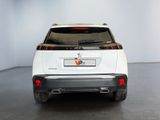 the rear end of a white suv parked in a white room