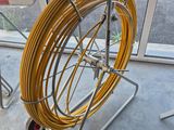 a cart that has a hose on it in front of a window
