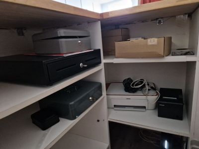 a shelf that has many different electronics on it