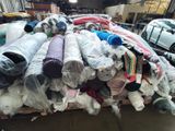 a large pile of clothes sitting on top of a pallet