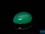 an image of a green jade stone on a black surface