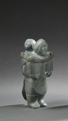 a statue of a man holding a baby in his arms