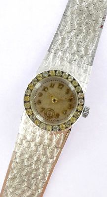 an image of a woman ' s wrist watch on a white surface