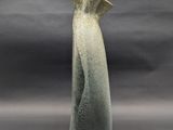 a vase that is sitting on a table with a gray background