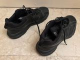 a pair of black shoes that are on the floor
