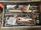 a drawer full of tools that are sitting on the floor