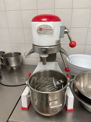 a mixer and a bowl on the counter in the kitchen