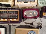 a lot of old radio ' s that are on the floor