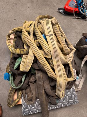 a pile of clothes on the floor next to a pair of shoes