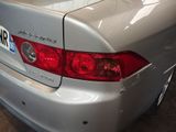 a picture of a silver car parked in a garage