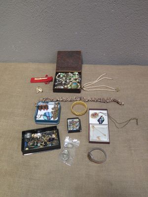 a lot of jewelry sitting on a table next to a wall