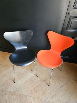two chairs sitting next to each other on a wooden floor