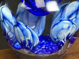 a glass vase with a blue and white design on it