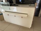 a white counter top with a tv on top of it
