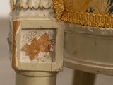 a close up of a chair with a painting on the back