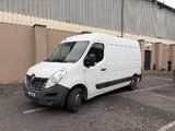a white van parked in a parking lot next to a building