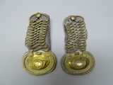 pair of antique brass plated door handles on a white background