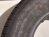 a close up of a tire on a white car