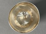 a small glass of water sitting on a table