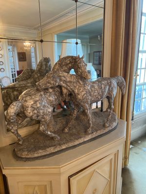 two horses that are standing on top of a table