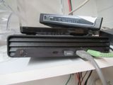 two dvd players sitting on top of each other on a shelf
