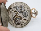 a close up of a pocket watch being held by a person