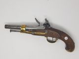an old gun that is on display on a white surface