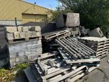 a pile of wooden pallets sitting on the side of the road