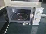 a microwave that is sitting on a counter with its door open