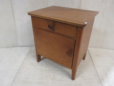 a small wooden table with a drawer on it