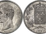 a silver coin with a crown on top of it