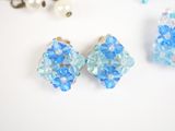 a pair of blue and white earrings and a pair of pearls
