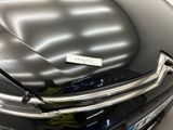 a close up of a black car with a sticker on it