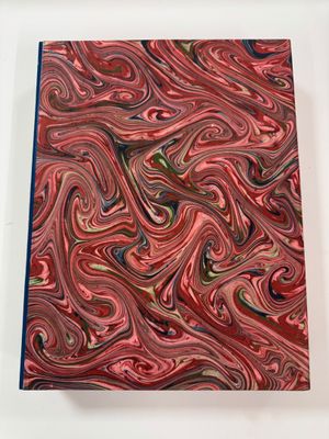 red, green, and blue marbled paper on a white surface