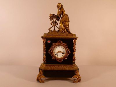 Pendule Borne en marbre noir et bronze surmontée d'une jeune…