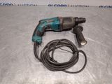 a close up of an electric drill on a table with a cord